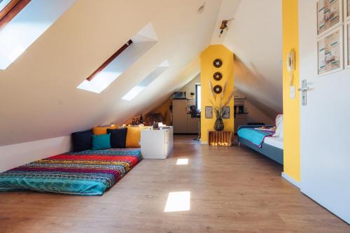 a attic room with two beds and a couch at Romantik Studio - Cozy - Stylisch - Naturnah in Kempen