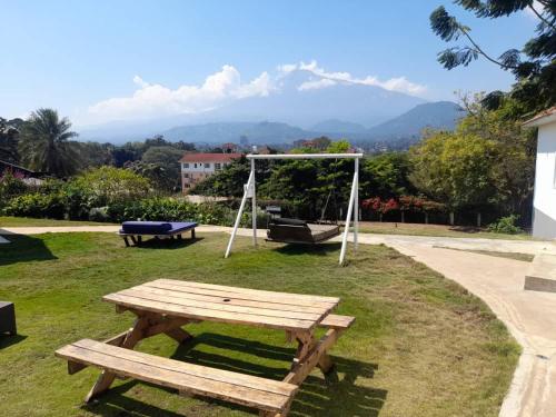 a picnic table and a swing in a park at Boulevard Inn Mt Meru in Arusha