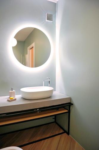 a bathroom with a white sink and a mirror at Casa Barca - Luxury Apartment in Agrigento