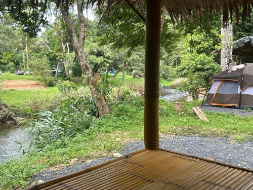 a view from the porch of a tent with a river at Khaosok August Freedom Camp in Khao Sok