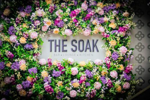 a wreath of flowers with the sax sign at The Clermont London, Victoria in London