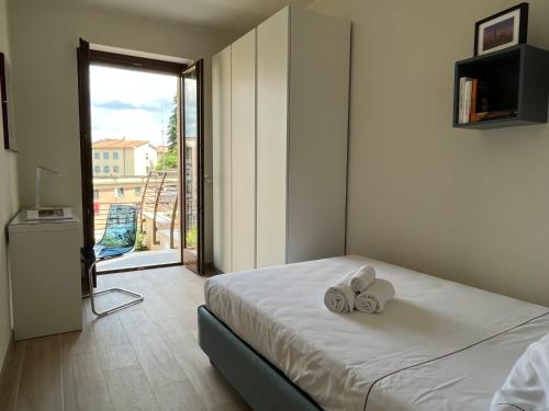 a bedroom with a bed with two towels on it at Sotto le Mura, appartamento Mosaico in Siena