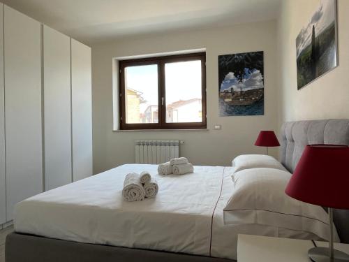 a bedroom with a bed with towels on it at Sotto le Mura, appartamento Mosaico in Siena