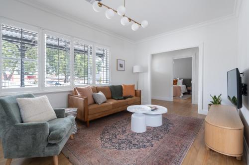 a living room with a couch and chairs and a tv at Field Street Cottages - 2 Bedroom House - Centrally Located Luxury in McLaren Vale