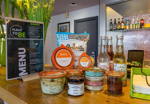 a counter with jars of food and bottles of alcohol at B&B HOTEL Chartres Centre Cathédrale 3 étoiles in Chartres