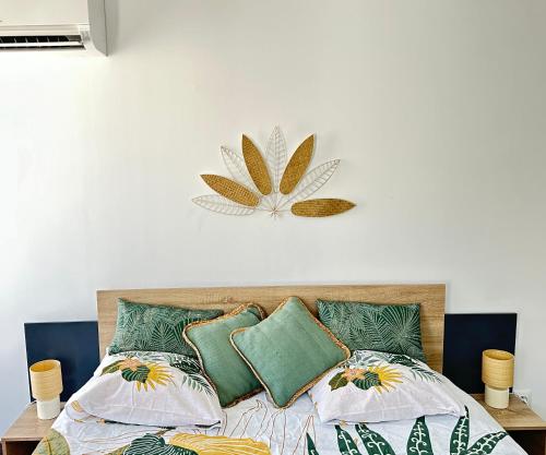 - une chambre avec un lit orné d'une fleur sur le mur dans l'établissement L'Amazonite, au Beausset