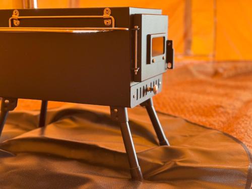 a camera on a tripod on a table at Fully Furnished Bell Tent 1 in St Austell