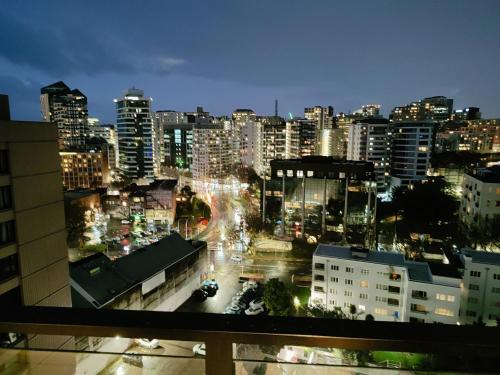 a view of a city at night with lights at Sky Stars CBD Apartment in Auckland