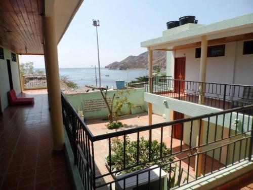 a balcony of a building with a view of the ocean at Hostal Dumbira in Taganga