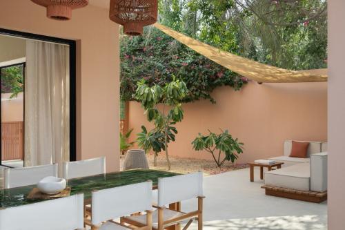 a dining room with a table and chairs at Meliá Desert Palm Member of Meliá Collection in Dubai