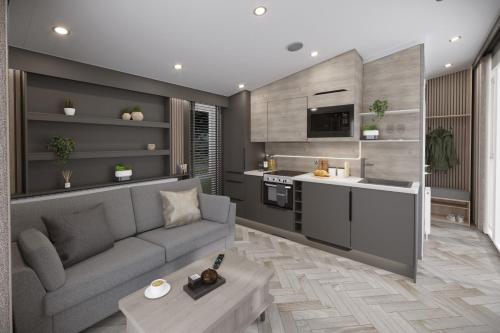 a living room with a couch and a kitchen at St. Ives Holiday Village in St Ives