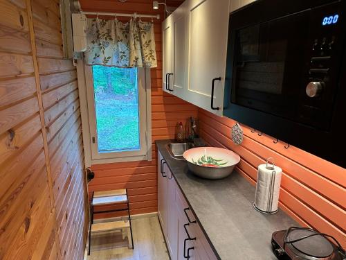 a small kitchen with a sink and a microwave at Villa vappu in Kuopio