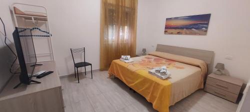 a small bedroom with a bed and a chair at Calliope in Terracina