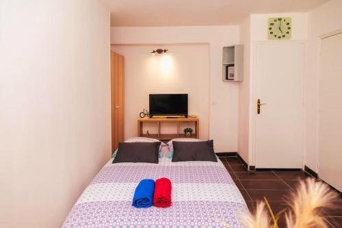 - une chambre avec un lit doté de deux tongs dans l'établissement Studio Cosy à St Ouen, à Saint-Ouen