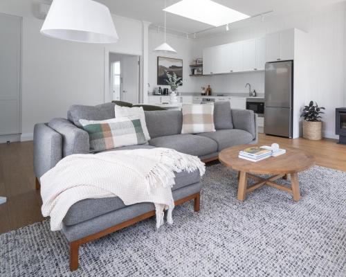 a living room with a couch and a table at Field Street Cottages 'Studio' - Centrally Located Luxury in McLaren Vale
