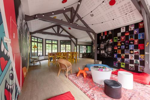 a room with a table and chairs and a wall with pictures at Village Pierre & Vacances Belle Dune in Fort-Mahon-Plage