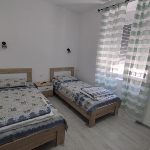 Postel nebo postele na pokoji v ubytování Apartmani 15