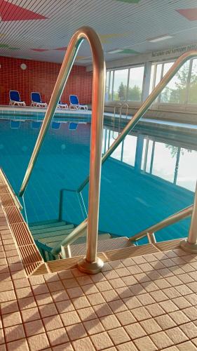an empty swimming pool with a stairway leading to a swimming pool at Apartment Gelassenheit Geyersberg - dein exklusiver Ort zum Ankommen & Genießen in Freyung
