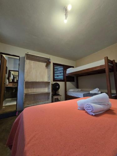 a bedroom with two bunk beds and a mirror at Stay Cool Pipa in Pipa