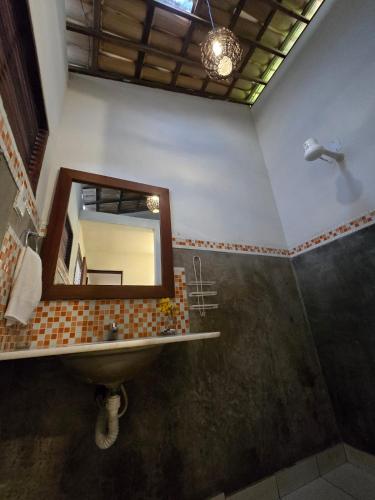 a bathroom with a sink and a mirror at Stay Cool Pipa in Pipa