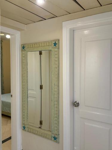 a mirror on a wall next to a door at Namaa Bay hotel Chalet in Sharm El Sheikh