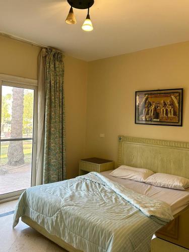 a bedroom with a large bed and a window at Namaa Bay hotel Chalet in Sharm El Sheikh