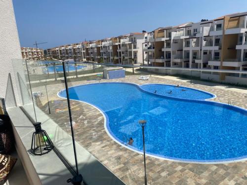 a large swimming pool on the balcony of a apartment at Mirador Golf 3 cappuccino in Cabo Negro