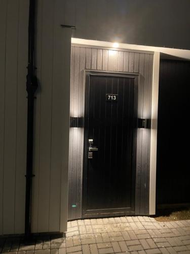 a black door with the on the side of a building at 5 bedroom house at the heart of Auckland Airport in Auckland