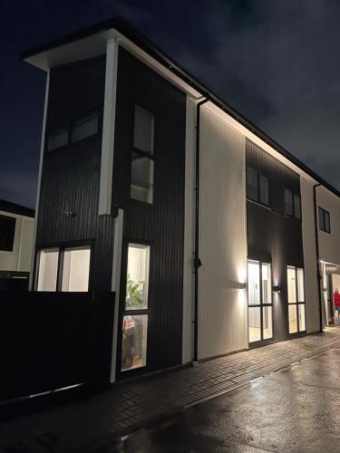 a large building with its doors open at night at 5 bedroom house at the heart of Auckland Airport in Auckland