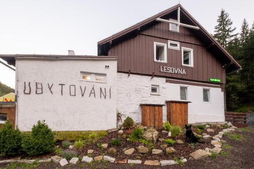 a building with a sign on the side of it at CHATA LESOVNA in Pec pod Sněžkou