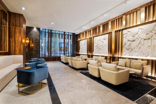 a lobby with couches and chairs in a building at Riu Plaza Chicago in Chicago