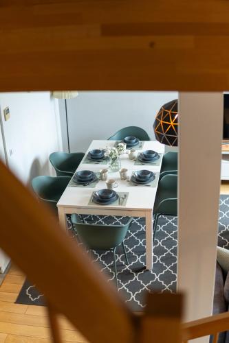 a table with chairs and a white table with at Apartementy Plac Solny 20 in Wrocław