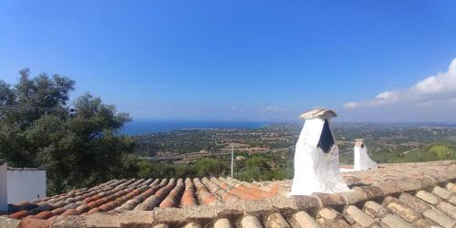 two dresses are sitting on top of a roof at suite paradiso in Quartu SantʼElena