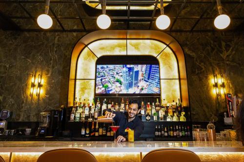 a man sitting at a bar with a drink at Riu Plaza Chicago in Chicago