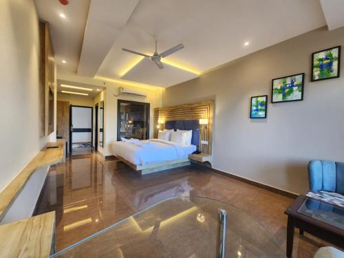 a bedroom with a bed and a glass floor at Aachman River and Valley View Resort Dharamshala - A riverside resort with balcony view in Dharamshala