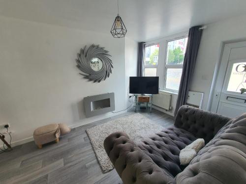 a living room with a couch and a television at 10 Pier Road Gillingham ME7 1RJ in Hoo