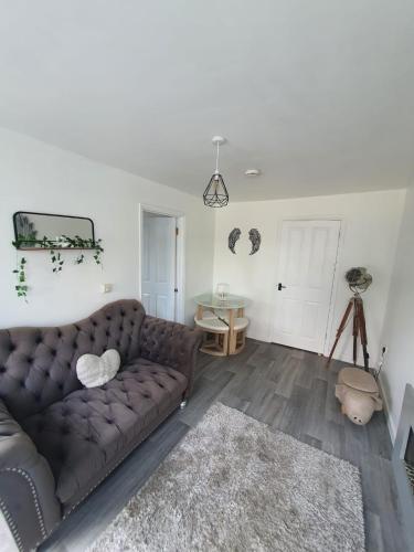 a living room with a brown couch and a rug at 10 Pier Road Gillingham ME7 1RJ in Hoo