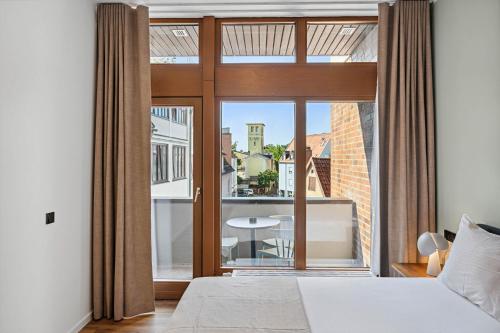 Ένα ή περισσότερα κρεβάτια σε δωμάτιο στο Limehome Memmingen Maximilianstraße