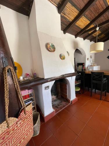 a living room with a fireplace in a house at Casa dos Anoes in São Luis