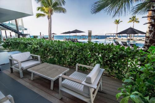 a patio with two chairs and a table and a table and chairs at The Ocean Club, a Luxury Collection Resort, Costa Norte in Sosúa