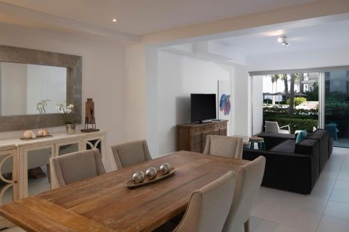 a living room with a wooden table and chairs at The Ocean Club, a Luxury Collection Resort, Costa Norte in Sosúa