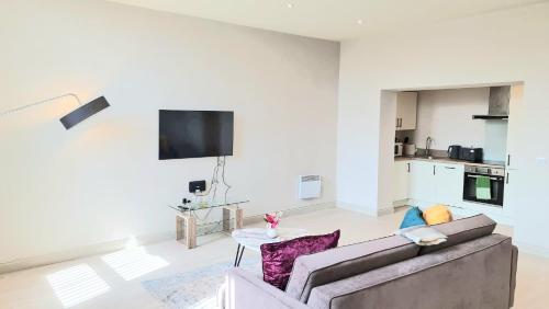 a living room with a couch and a table at KEST Luxury Apartment in Leeds