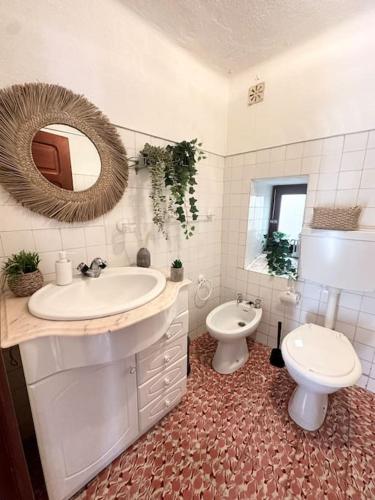 a bathroom with a sink and a toilet and a mirror at Cozy 2BR apartment in Loriga by Soulplaces in Loriga