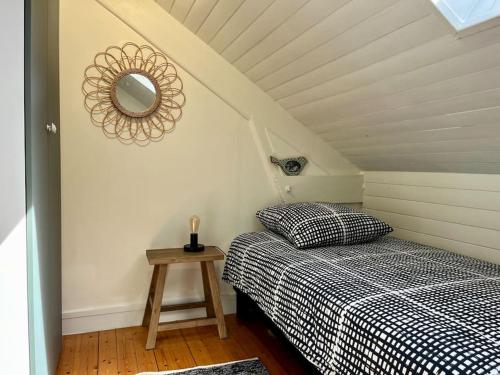 une chambre avec deux lits et un miroir au mur dans l'établissement LE GITE DE SOANI avec terrasse & jardin, à Saint-Évarzec