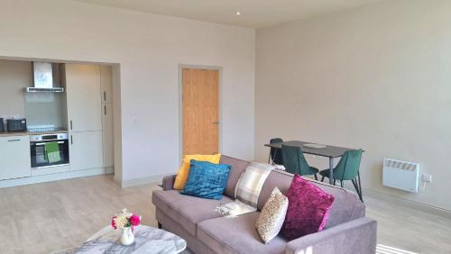 a living room with a couch and a table at KEST Luxury Apartment in Leeds