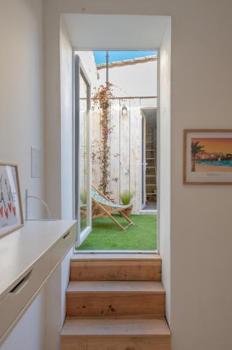 a staircase leading to a room with a sliding glass door at Maison ANA in Cadillac