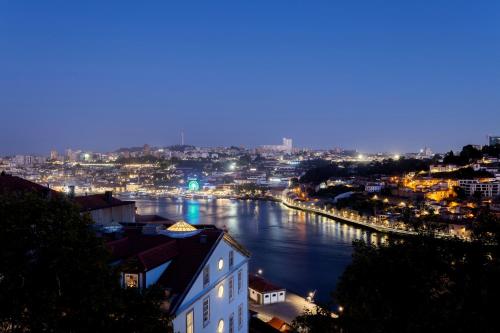 a view of a river in a city at night at Altis Porto Hotel in Porto