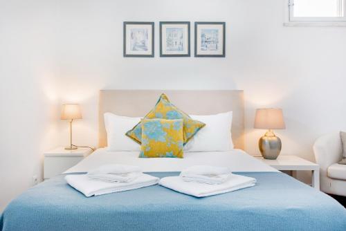 a bedroom with a bed with two towels on it at Park View Central Apartment in Cascais in Cascais
