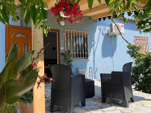 a group of chairs sitting outside of a house at Rama Guest House in Berat