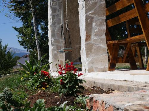 a garden outside of a house with flowers at Chalet with Barbecue in Brezna in Pluzine